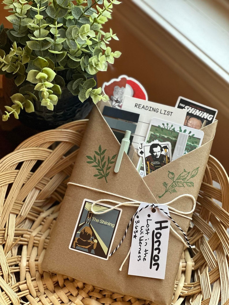 Wrapped blind date with a book in the Horror genre with horror-themed stickers and colors.