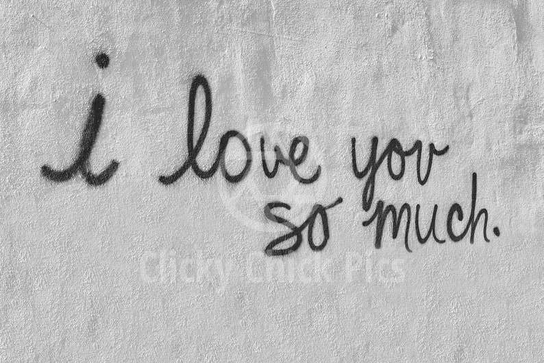 May include: A black and white image of a handwritten message on a textured wall that says "i love you so much."