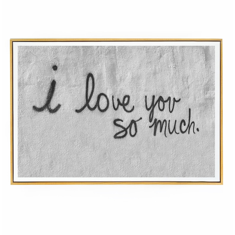 May include: A black and white framed print with the text "i love you so much." written in black cursive on a gray textured background.
