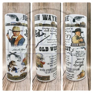 May include: A white tumbler featuring a collage of images and text related to John Wayne and the Wild West. The tumbler includes a quote from John Wayne, "Courage is being scared to death but saddling up anyway."  The tumbler also features images of John Wayne, horses, and guns.