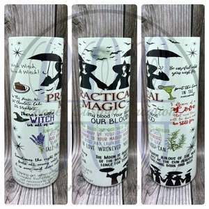May include: A white tumbler featuring a black and white illustration of two witches with the text "Practical Magic" and other quotes about witches and magic.