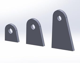 May include: Three gray metal tabs of varying sizes, each with a circular hole near the top. The tabs have a flat, rectangular base and a rounded top. The sizes range from small to large.
