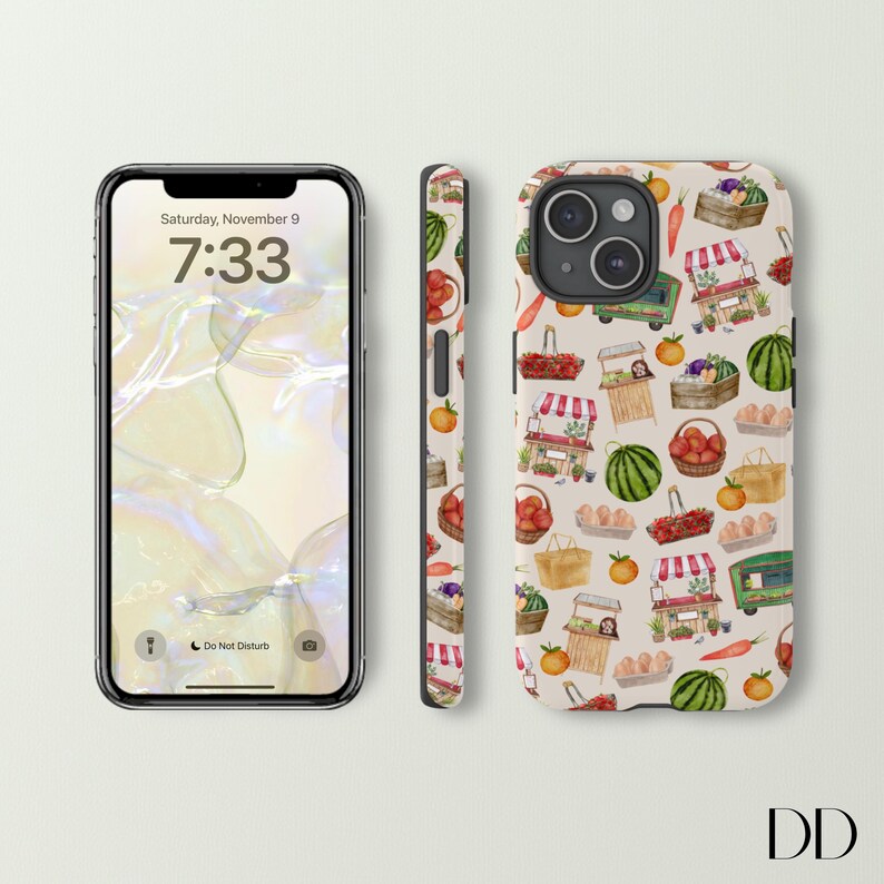 May include: A smartphone and phone case featuring a repeating pattern of a farmer's market. The pattern includes illustrations of produce, market stalls, baskets, and a green truck. The phone screen displays the time as 7:33 and the date as Saturday, November 9.