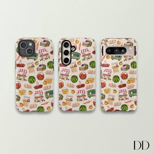 May include: Three phone cases with a repeating pattern of a farmer's market scene. The design includes green market carts, baskets of produce, watermelons, and tomatoes on a cream background. The cases are for different phone models.