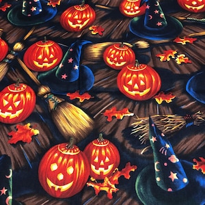 May include: A Halloween-themed pattern featuring carved orange jack-o'-lanterns, witch hats with star and moon designs, and straw brooms. Red and orange autumn leaves are scattered across the dark brown background. The design is festive and seasonal.