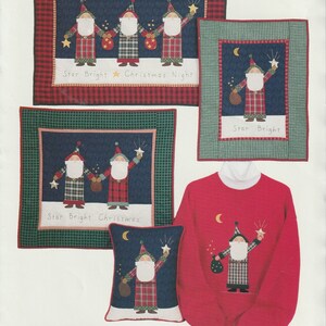 May include: A set of four applique patterns featuring Santa Claus with a star and a bag of gifts. The patterns are on a blue background with a red and green plaid border. The text "Star Bright Christmas Night" and "Star Bright Christmas" is included in the image.