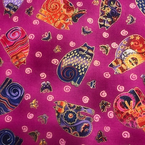 May include: Magenta fabric with a repeating pattern of colourful, stylised cats and butterflies. The cats are in blue, orange, and purple, with gold detailing. Butterflies and spiral designs are scattered across the fabric.