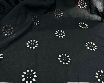 May include: Black fabric with a repeating pattern of small, circular cutouts. The fabric has a soft, sheer texture.