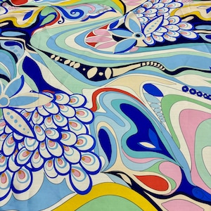 May include: Abstract fabric with a swirling pattern of blue, green, pink, and yellow. The fabric features a repeating design of stylized flowers and leaves.