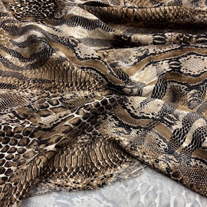 May include: Brown and black fabric with a snakeskin pattern.