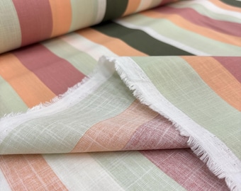 May include: Close-up of a striped fabric with a frayed edge. The fabric features vertical stripes in shades of peach, olive green, dusty rose, and white. The fabric appears to be a linen or cotton blend, suitable for apparel or home decor.