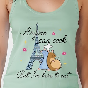 May include: A light green tank top with a graphic of two cartoon rats in front of the Eiffel Tower. The text on the shirt reads "Anyone can cook but I'm here to eat."