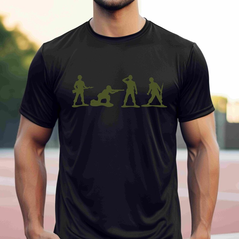 Puede incluir: Una camiseta negra con un gr&aacute;fico de cinco soldados de juguete verdes en diferentes poses. Los soldados sostienen armas y est&aacute;n en fila.