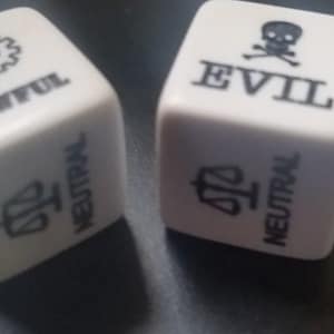 May include: Two white dice with black markings. One die has a gear symbol and the word "LAWFUL" on one side and a scale symbol and the word "NEUTRAL" on another side. The other die has a skull and crossbones symbol and the word "EVIL" on one side and a scale symbol and the word "NEUTRAL" on another side.