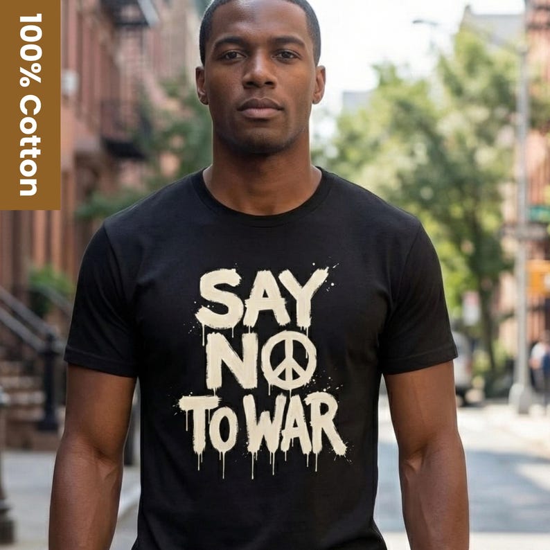 May include: Black t-shirt with the text "SAY NO TO WAR" in white, featuring a peace symbol. The shirt is made of 100% cotton. The person in the image is wearing the shirt.