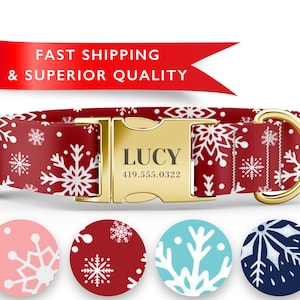 May include: Red dog collar with a white snowflake pattern and a gold buckle. The buckle is engraved with the name "LUCY" and the phone number "419.555.0322". The collar is shown with four different color variations of the snowflake pattern: pink, red, blue, and navy.
