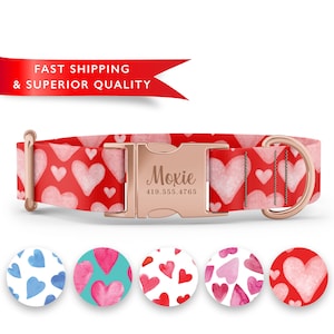 May include: A red dog collar with a pink watercolor heart pattern and a rose gold buckle. The buckle has the name "Moxie" and a phone number engraved on it. The collar is shown with five different heart pattern options.