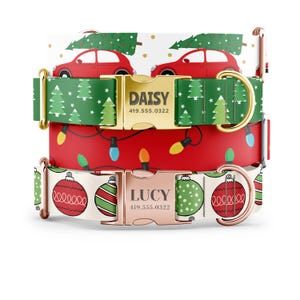 May include: Three dog collars with Christmas themes. The top collar is green with white Christmas trees and red cars. The middle collar is red with white Christmas lights. The bottom collar is white with red and green ornaments. Each collar has a gold or rose gold buckle with a personalized name and phone number. The top buckle says "DAISY 419.555.0322" and the bottom buckle says "LUCY 419.555.0322".