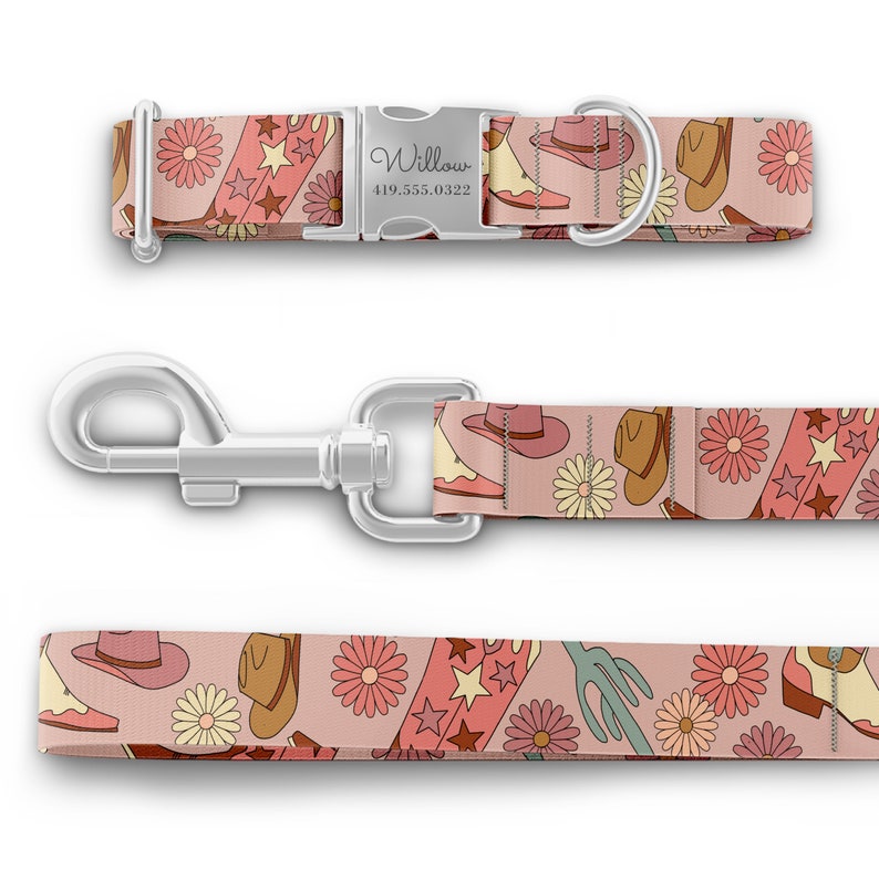 May include: A pink dog collar and leash set with a cowboy boot, hat, and flower pattern. The collar has a silver buckle with the name "Willow" and a phone number.