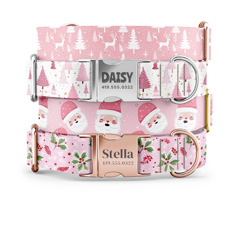 May include: Two pink dog collars with silver and rose gold buckles. The top collar has a white background with pink Christmas trees and reindeer. The bottom collar has a pink background with a red and white Santa Claus pattern. Both collars have personalized name tags with phone numbers.