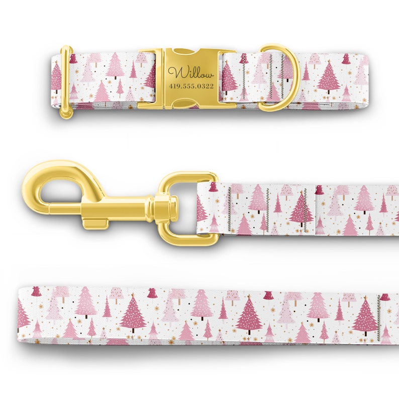 May include: A white dog collar with a pink and gold Christmas tree pattern. The collar has a gold buckle with the name "Willow" and phone number "419.555.0322" engraved on it. The collar is paired with a matching leash.