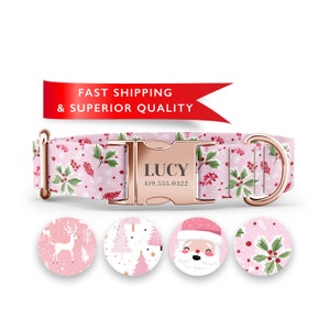 May include: Pink dog collar with a rose gold buckle and a holly and snowflake pattern. The buckle is personalized with the name "LUCY" and the phone number "419.555.0322". The collar comes with four different interchangeable charms: a reindeer, a Christmas tree, Santa Claus, and a holly sprig.