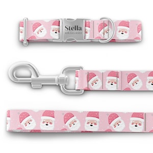 May include: Pink dog collar and leash set with a Santa Claus pattern. The collar has a silver buckle with the name "Stella" and a phone number engraved on it.