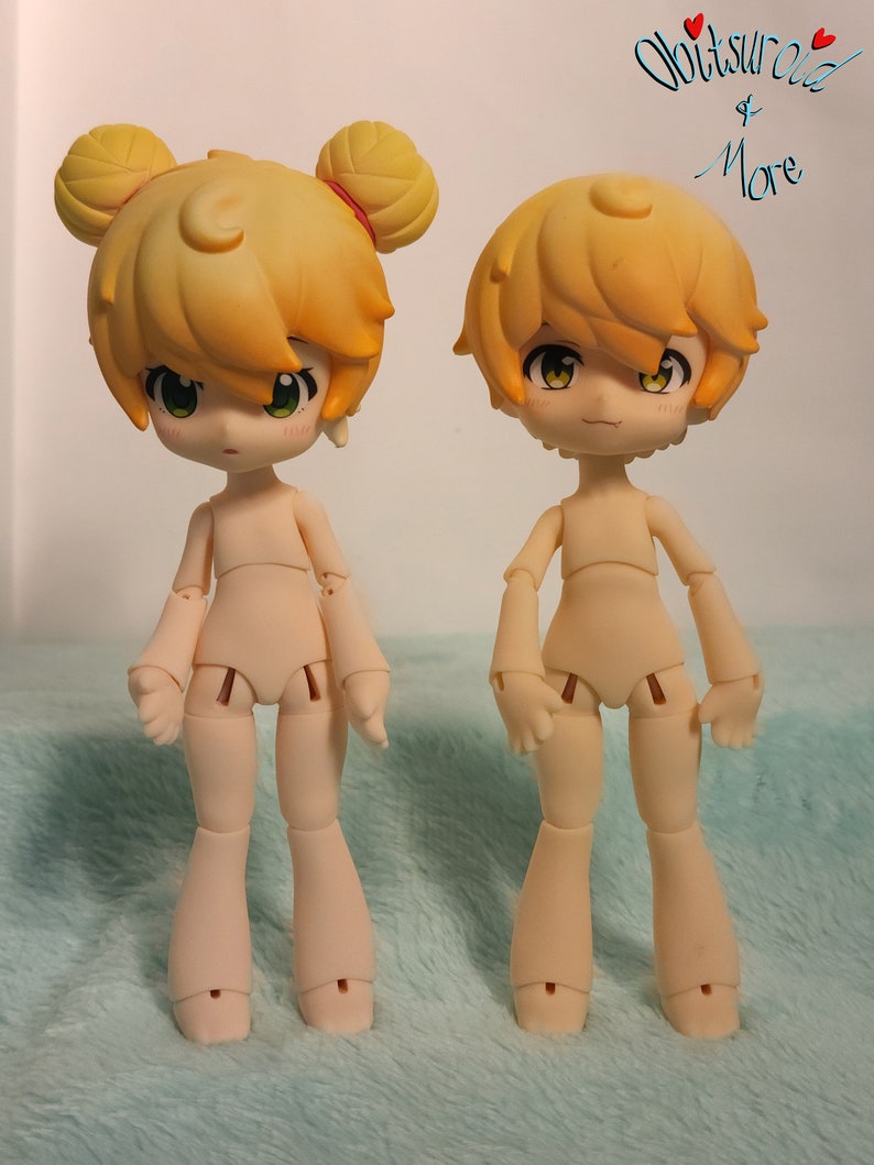 May include: Two nude-colored articulated dolls with yellow hair. The doll on the left has two yellow hair buns on top of its head. The doll on the right has a single yellow hair bun on top of its head.