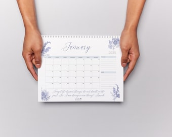 May include: A white calendar with a floral design and the month of January 2025. The calendar has a quote: "Forget the former things; do not dwell on the past. See, I am doing a new thing!" Isaiah 43:19