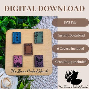 May include: A wooden display featuring miniature book covers in various colors, including blue, green, brown, purple, and pink. The text "DIGITAL DOWNLOAD" and "The Bear Naked Duck" are visible. Additional text includes "SVG File," "Instant Download," and "6 Covers Included."