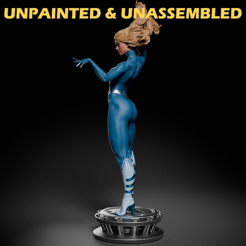 May include: Unpainted and unassembled blue plastic figurine of a woman with blonde hair standing on a circular base. The figurine is posed with one arm raised and the other arm extended out to the side.