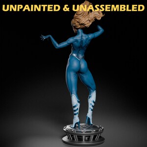 May include: Unpainted and unassembled blue plastic figurine of a woman in a superhero pose. The figurine is standing on a circular base.
