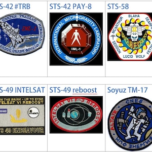 May include: A collection of nine embroidered patches from various NASA space missions, including STS-42, STS-49, STS-58, and Soyuz TM-17. The patches feature colorful designs and text, including the mission names, crew members' names, and mission objectives.