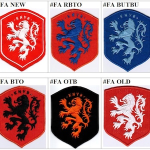 May include: Six embroidered patches featuring the Dutch national lion emblem in various color combinations. The patches are red, blue, black, orange, and white. The patches are all in the same style, with a shield shape and the text "KNVB" in the top center.