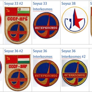May include: A collection of eight embroidered patches featuring the Soyuz spacecraft and the Interkosmos program. The patches are red, white, blue, and gold with various national flags and text in Cyrillic.