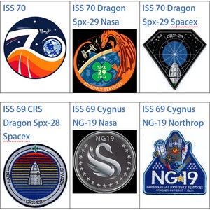 May include: A collection of eight circular and triangular patches with various designs, including a dragon, a spaceship, and a swan. The patches are all in different colors and have text on them, such as "ISS 71", "ISS 70", "Spx-29", and "NG-19".