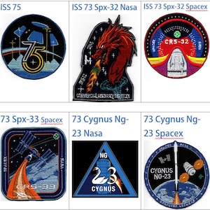 May include: A collection of embroidered patches featuring space-themed designs. The patches display various logos, spacecraft, and text, including "ISS 76", "ISS 75", "HTV-X1", and "73 Cygnus Ng-23". The patches are in various shapes and colors.