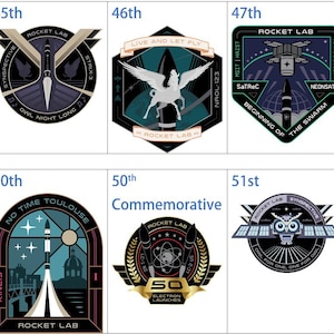 Op de afbeelding: Een verzameling Rocket Lab-missie-emblemen, elk met unieke ontwerpen en tekst. De emblemen tonen raketten, hemellichamen en gestileerde afbeeldingen in een palet van blauw, wit en zwart. De tekst bevat missienamen en -nummers.