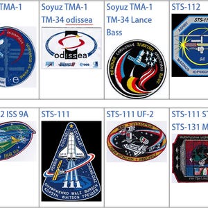 May include: A collection of eight space mission patches, including Soyuz TMA-1, STS-112, STS-111, and STS-131. The patches feature colorful designs with text and imagery related to the missions.