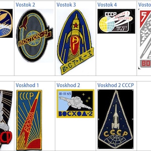 May include: A selection of embroidered patches depicting Soviet space program imagery. Designs include rockets, spacecraft, and the CCCP emblem, with Cyrillic text. The patches vary in shape and colour, showcasing historical space exploration.