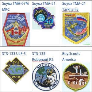 May include: A collection of nine embroidered patches featuring various space mission logos. The patches are rectangular and square in shape and feature a variety of colors, including red, blue, white, and gold. The patches are arranged in a grid pattern.