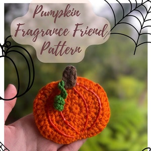May include: Crochet pumpkin pattern for a small orange pumpkin with green leaves and a brown stem. The pattern is called "Pumpkin Fragrance Friend Pattern" and is available as a PDF download. The pattern is by @kaumanacrochetcrafts.