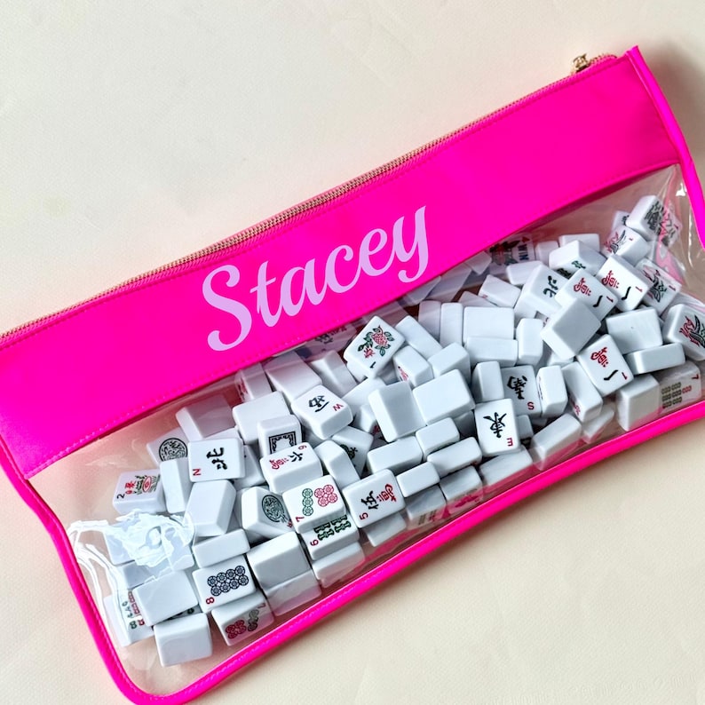 Bright pink personalized Mahjong tile bag with custom name Stacey and clear vinyl front filled with Mahjong tiles.