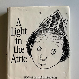 May include: A Light in the Attic book cover. The cover is off-white with black text and illustrations. The title is in large, bold letters. The illustration is a whimsical drawing of a face with a house on top of the head. The author's name is Shel Silverstein.
