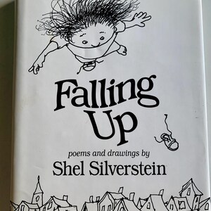 May include: A white book cover with the title "Falling Up" in large black letters. The cover features a whimsical black and white illustration of a child floating in the air, with a shoe falling. The author's name, Shel Silverstein, is also printed.