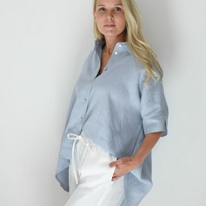 Oversized loose linen button up shirt for women in light blue color with long back and half sleeves