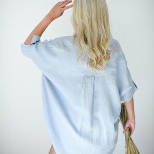 Oversized loose linen button up shirt for women in light blue color with long back and half sleeves