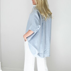 Oversized loose linen button up shirt for women in light blue color with long back and half sleeves