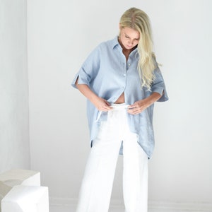 Oversized loose linen button up shirt for women in light blue color with long back and half sleeves