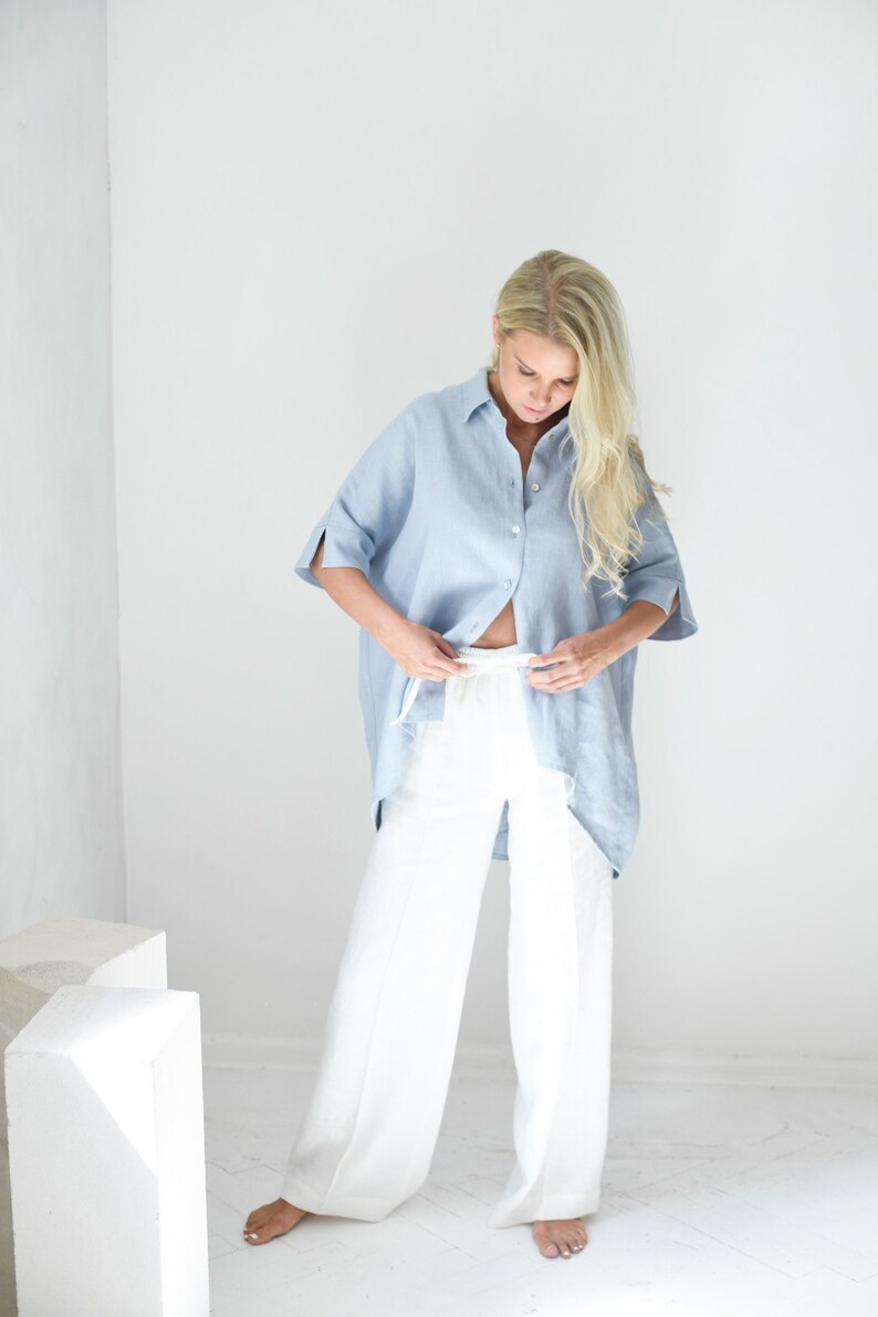 Oversized loose linen button up shirt for women in light blue color with long back and half sleeves